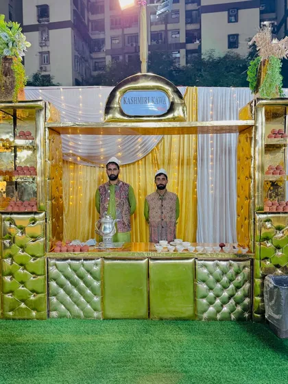 My traditional Kashmiri Kahwa station, with servers in authentic attire, offering a warm and aromatic welcome to guests.