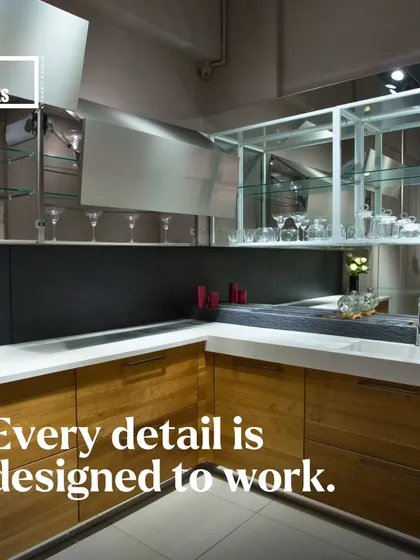 Here, we've used open glass shelving and lift-up cabinets to create a bar area within the kitchen, combining display and function.