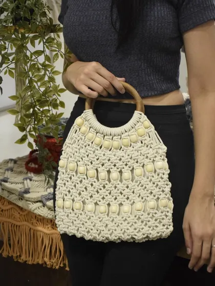 Another view of our beaded macramé tote with a wooden handle. It's a testament to how we blend natural materials to create functional art.