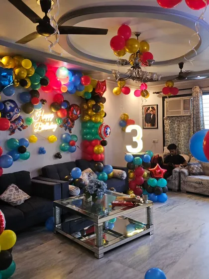 Another angle of the full-room Marvel decoration, highlighting the light-up number '3' and the different balloon arrangements used throughout the space.
