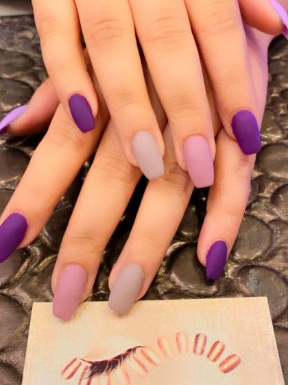 A stylish and modern set of square nails. The design features a mix of solid matte purple and matte mauve-pink for a chic, color-blocked look.