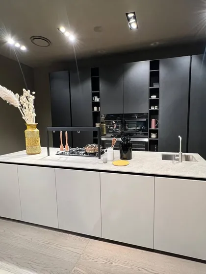 A chic and classy island kitchen design. The two-tone effect with a white island and black full-height cabinets creates a simple yet powerful statement.