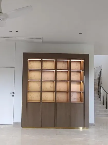 A large-scale custom display cabinet with integrated lighting, delivered to a client's home. This piece was designed to be a major architectural feature, providing ample space for display and storage.