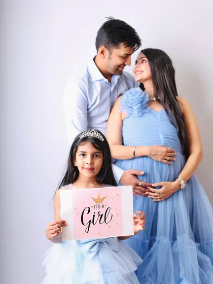 Welcoming a new baby is a family affair. I love including older siblings in the shoot to capture their excitement, like in this sweet gender reveal photo for a baby girl.