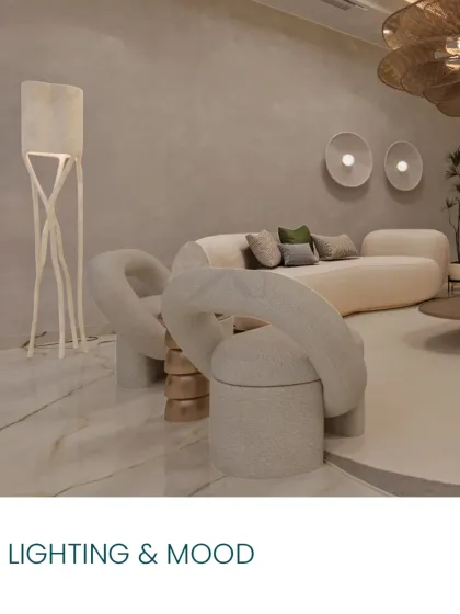 Lighting and mood are crucial. Here, sculptural chairs and a unique floor lamp create an artistic and inviting corner.