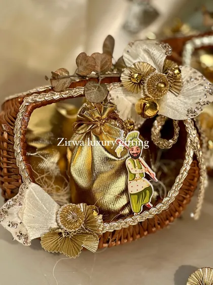 This close-up shows the details of my Lohri baskets. The small dancing bhangra man cutout adds a playful and authentic touch to the golden-themed arrangement.
