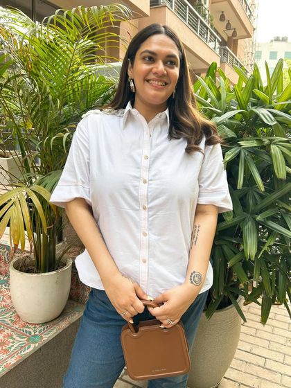 The classic summer uniform: a white shirt and blue jeans. This shirt from Stitch Stories has the cutest floral detailing on the shoulders, a small touch that elevates a timeless piece.