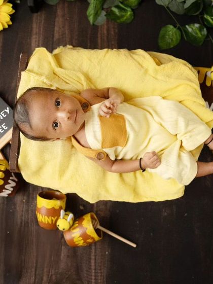 A rare and precious awake moment during a newborn shoot. This little honey bee is looking right at the camera.