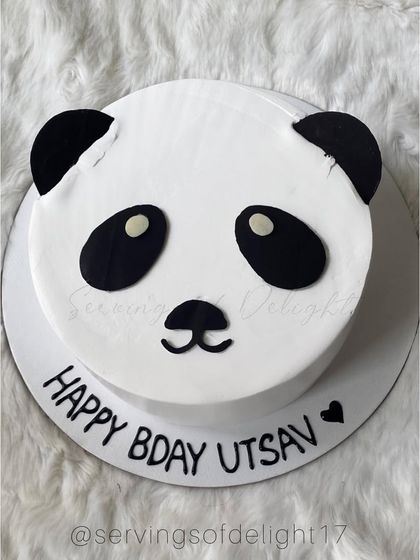 A cute and simple panda cake for a first birthday. The minimalist design is adorable and perfect for a modern animal-themed party.