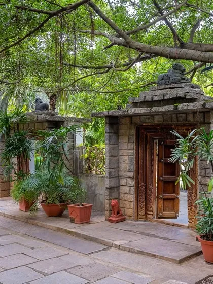 Every path here is an invitation to explore. This walkway, lined with stone pillars and lush plants, leads to another of the venue's hidden gems.