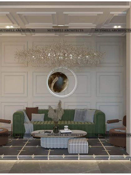 This cozy seating area within a larger room is defined by its classic wall paneling and a stunning linear chandelier. The deep green sofa and houndstooth-patterned ottoman add a touch of classic charm and personality.