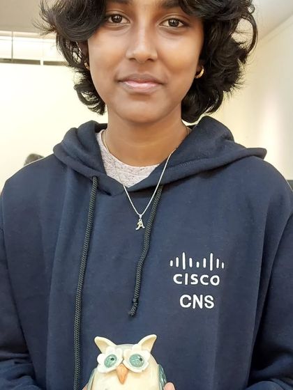 A young art lover holding one of my owl figurines at the Bengaluru Potter's Market. It's wonderful to see the next generation appreciate handmade crafts.