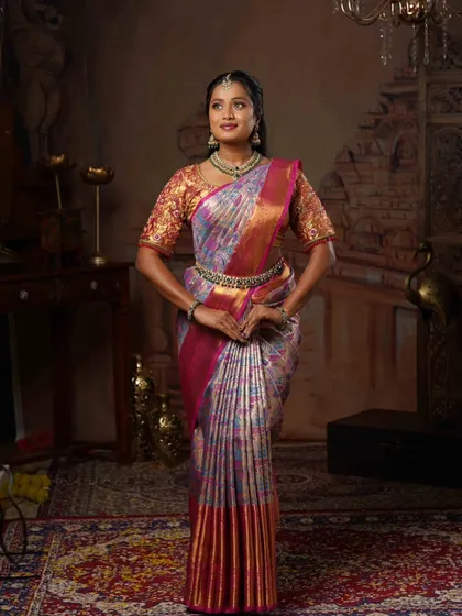 A classic pose that highlights the full effect of the saree draping. The combination of a secure fit and elegant pleats ensures you look your best for any occasion.