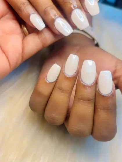 A close-up of a milky white manicure. This semi-sheer white is a softer, trendier alternative to an opaque white.