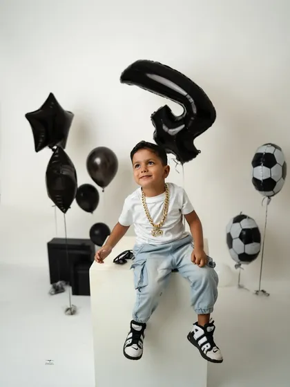 A sweet, upward glance from the four-year-old birthday boy. Even in a cool, modern setup, we can capture moments of pure childhood innocence.