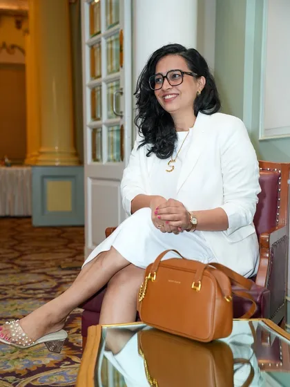 A candid photo from a business conference. My all white formal suit reflects a clean, professional look suitable for high-level corporate gatherings.