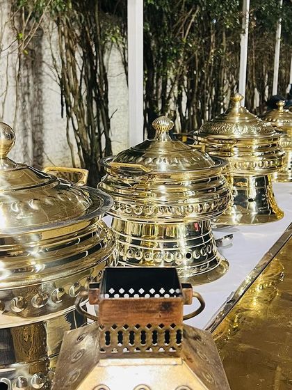My collection of ornate, polished brass chafing dishes and serveware. I believe the presentation is just as important as the taste, and this setup adds a touch of royalty to any buffet line.
