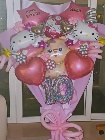 A full view of the custom Hello Kitty giant hand balloon bouquet. It's a dream come true for any fan, featuring the birthday girl's name and age for a personalized touch.