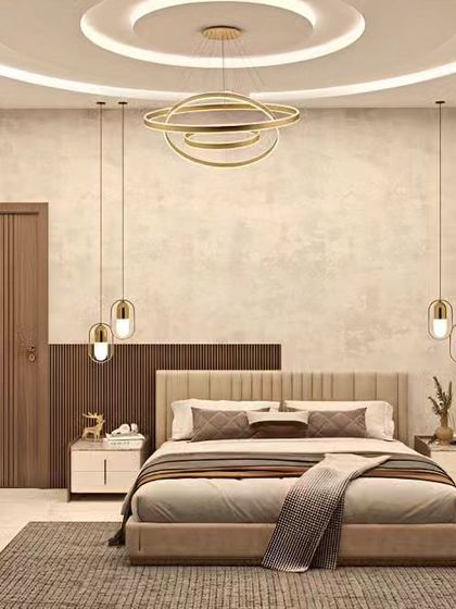 An elegant bedroom featuring a neutral color palette and sophisticated lighting. The design includes a stunning chandelier, pendant lights over the nightstands, and a beautiful coffered ceiling.