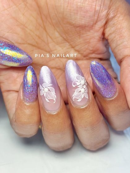 A beautiful combination of purple glitter, iridescent chrome, and delicate white floral art.