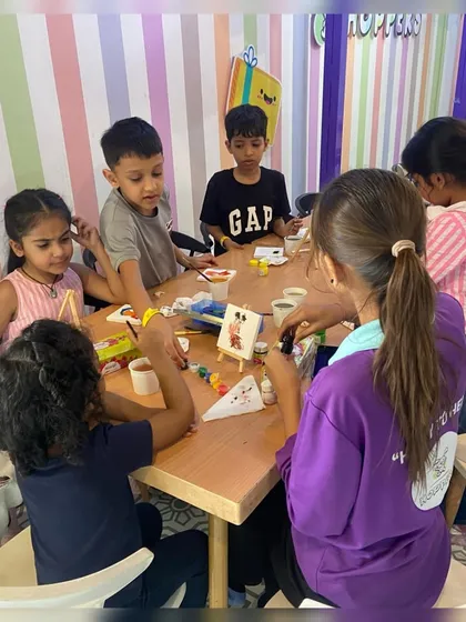 A moment of focused fun during one of our creative workshops. We offer a variety of hands-on activities like canvas painting, providing a calm and engaging alternative to the high-energy play zone.