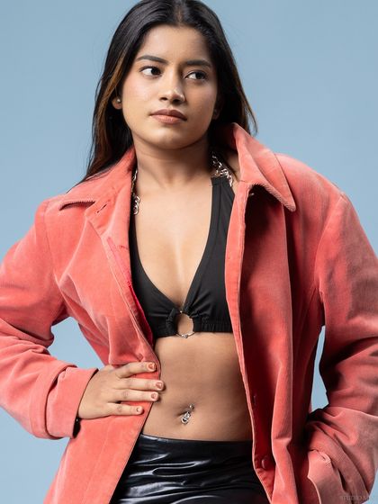 A close-up portrait from the same shoot, focusing on the model's confident expression.