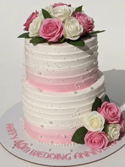 Forty years of love is a milestone worth celebrating in style. I crafted this elegant two-tiered cake with a fresh pineapple flavor and a beautiful pink ombre buttercream design, adorned with fresh roses for a timeless look.