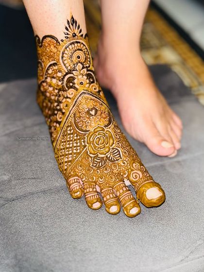 A single-foot view, showing the intricate details of the design. The rose motif is a beautiful centerpiece.