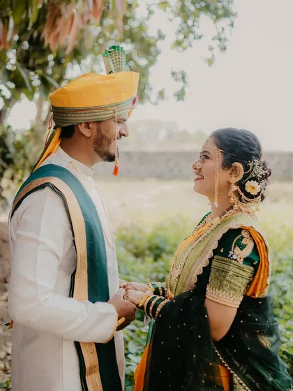 A classic and elegant pose, with the couple holding hands and looking at each other. This shot captures a sense of timeless romance and partnership.