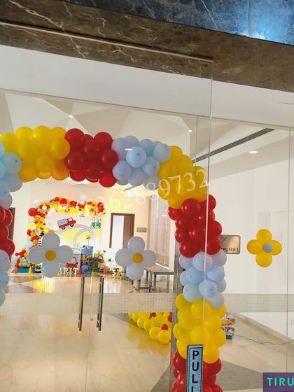 A bright and cheerful balloon arch in primary colors, creating a playful entrance for a car themed party.