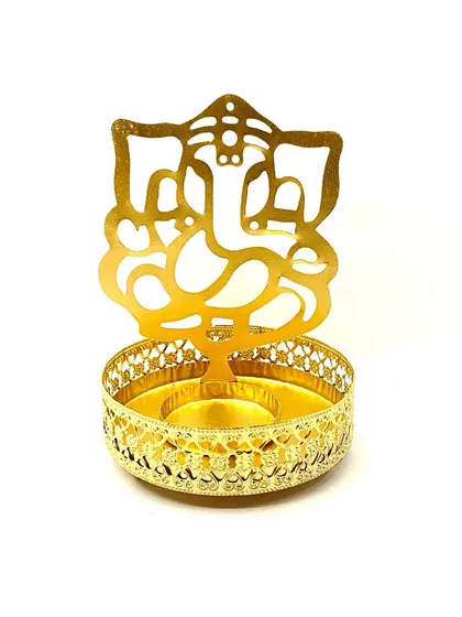 A beautifully crafted golden metal holder designed to be used with a tealight candle. The intricate cutout creates a lovely shadow of Lord Ganesha, making it perfect for your home temple or as a spiritual gift.