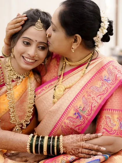 A mother's love and a daughter's smile. The makeup is elegant and understated, perfect for this heartwarming family moment.