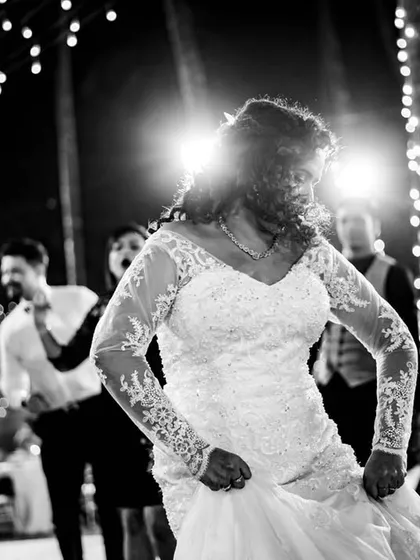 The bride lets loose on the dance floor. This high-energy, black and white shot captures the fun and freedom of the wedding party.