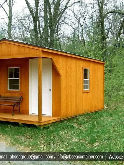 This porta cabin is designed with a charming wooden exterior and a small porch, making it suitable for use as a guesthouse, a small site office, or a cabin at a farm.