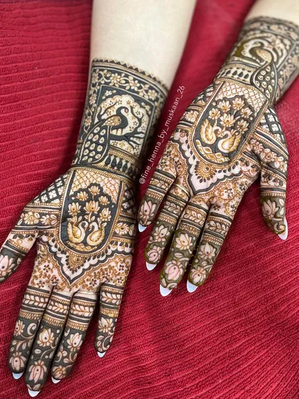 A beautiful roka mehndi design filled with swan and lotus motifs. The negative space makes the birds stand out.