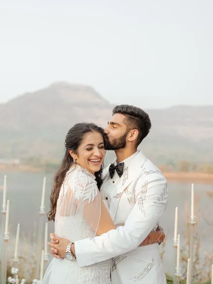 A gentle kiss on the forehead, a moment of pure love and affection against the backdrop of the mountains and lake. This intimate portrait is what timeless wedding photography is all about.