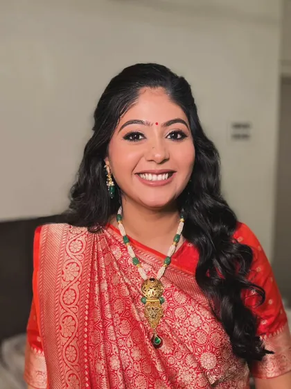 A glowing mom-to-be in a traditional red saree for her baby shower. I created a classic look with defined eyes and a small bindi to complete the look.