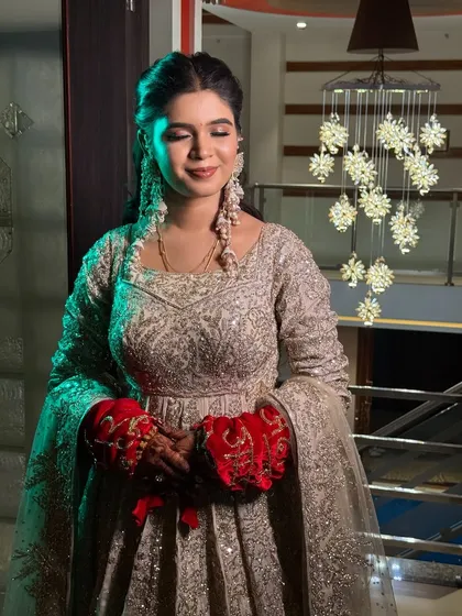 A real bride's reception look in a shimmering silver gown, with unique red hand-covers.