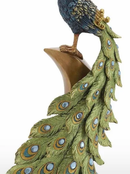 And this is the 'after'. A beautifully painted and detailed peacock sculpture, showing the final result of our clay art workshops.