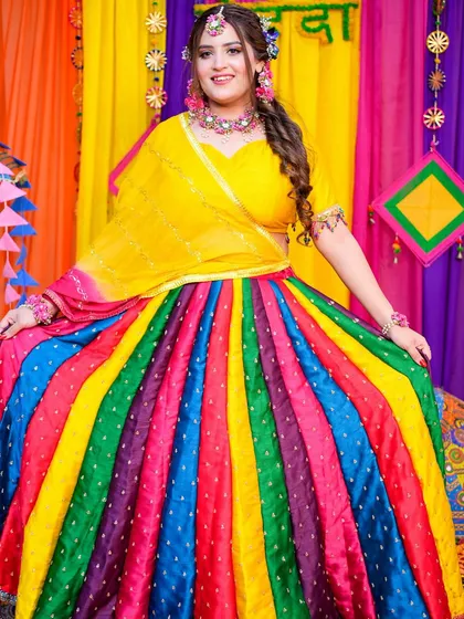 The full rainbow lehenga for the Mehendi function. The makeup is bright and festive to match the cheerful vibe.
