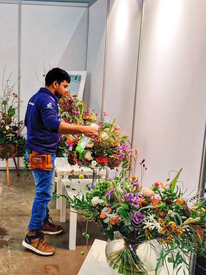 An IFD-trained competitor meticulously works on his arrangement at a global flower platform. Our training prepares students to compete and excel on the world stage.