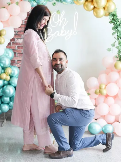 An expecting couple during their baby shower celebration. I photograph these events to capture the excitement, from the beautiful decor to the intimate moments between partners as they prepare for their new arrival.