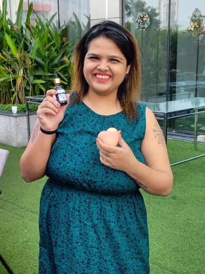 A happy customer holding her new hair oil and a heart-shaped soap at the Vivanta Navi Mumbai Christmas Flea Market.
