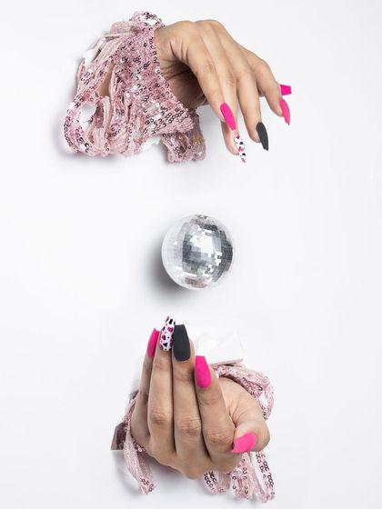 A fun and edgy design combining matte fuchsia pink with a black and white animal print accent nail. This is a great example of how to mix colors and patterns for a standout look.