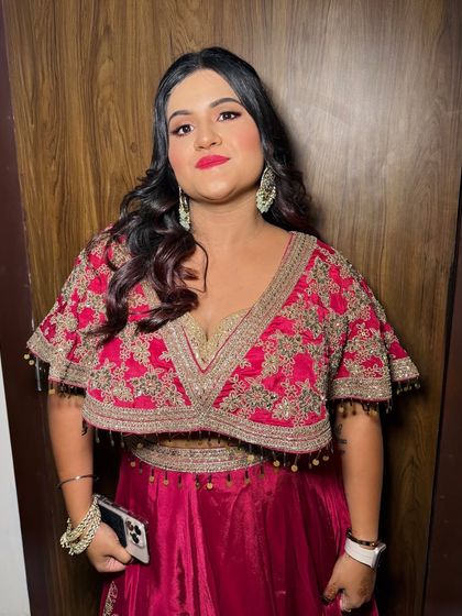 A confident pose showing off the full look. The hairstyle is soft waves, perfect for a party.