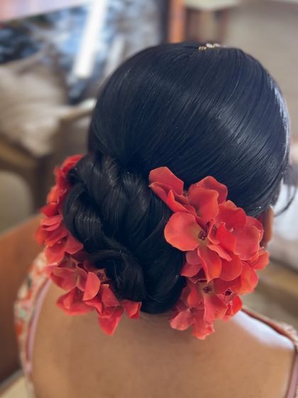 A close up of the vibrant red floral bun, showing the fullness of the flowers.