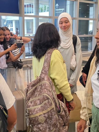 Our students at the airport, excited for their international journey. These experiences build their confidence both on and off the mat.
