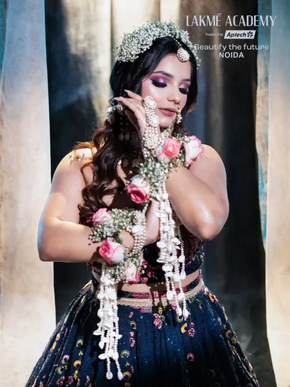 This image highlights the intricate floral and shell hand jewelry (hathphool) that completes the Haldi look. Our courses cover not just makeup, but overall styling.