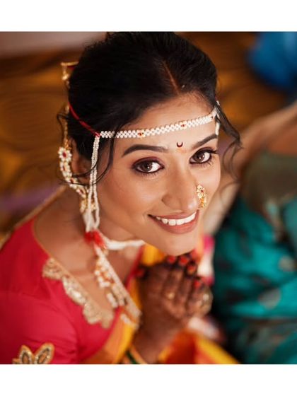 A beautiful high-angle shot of the bride looking up with a sweet smile during her wedding ceremony.