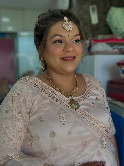 A classic and elegant look for a mature client. The makeup is soft and enhances her features, paired with a traditional updo and maang tikka.